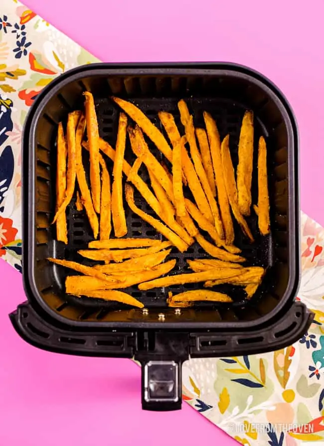 Air Fryer with sweet potato fries in it.