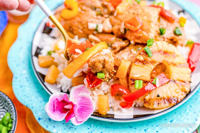 A blue plate with Hawaiian chicken on it.