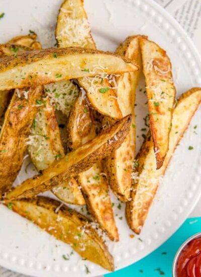 A plate full of potato wedges.