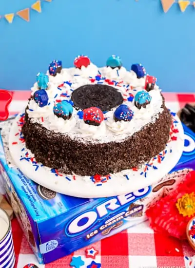 An oreo ice cream cake with red white and blue oreos and decorations.