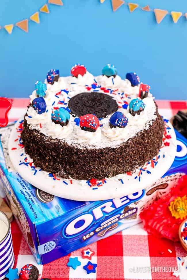 An oreo ice cream cake with red white and blue oreos and decorations.