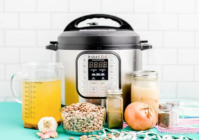 An instant pot with the ingredients to make refried beans.
