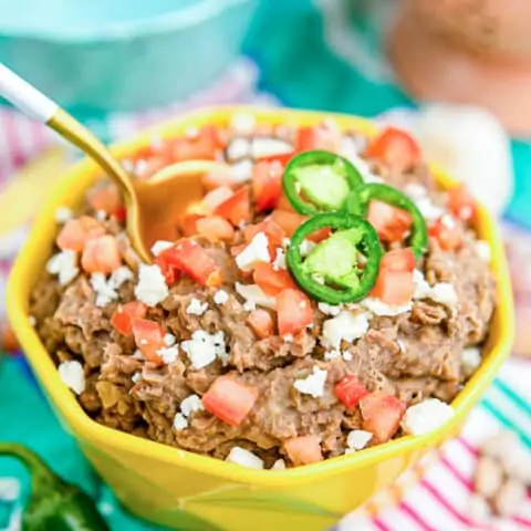Instant Pot Refried Beans in a yellow bowl.