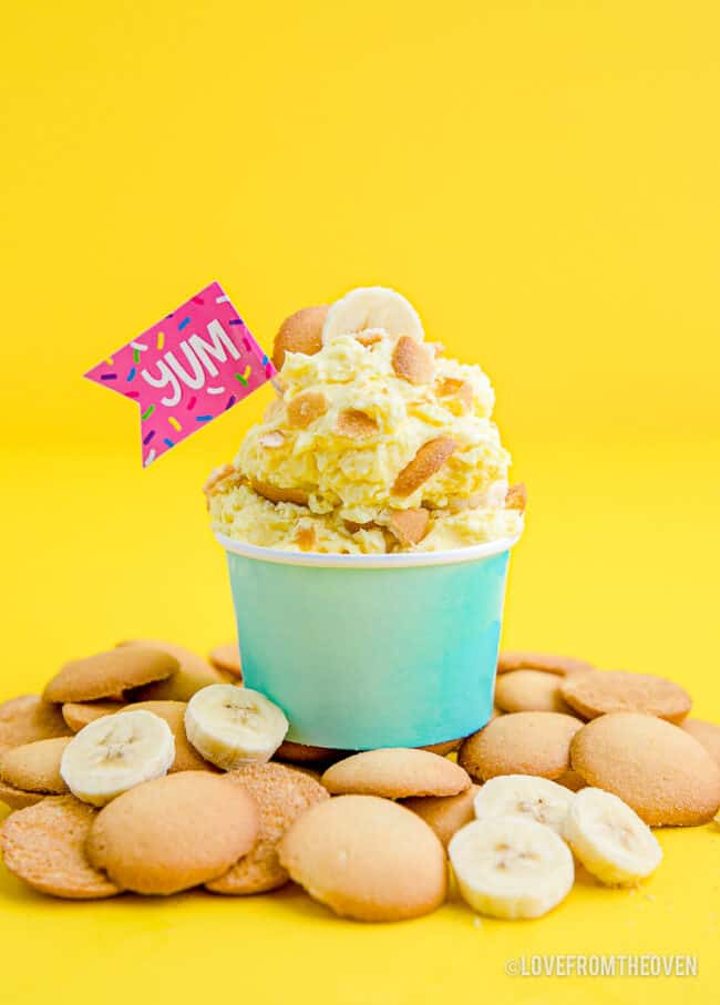 A cup of banana pudding with vanilla wafers.