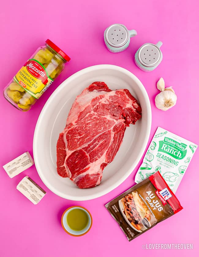 ingredients for mississippi pot roast on a pink background