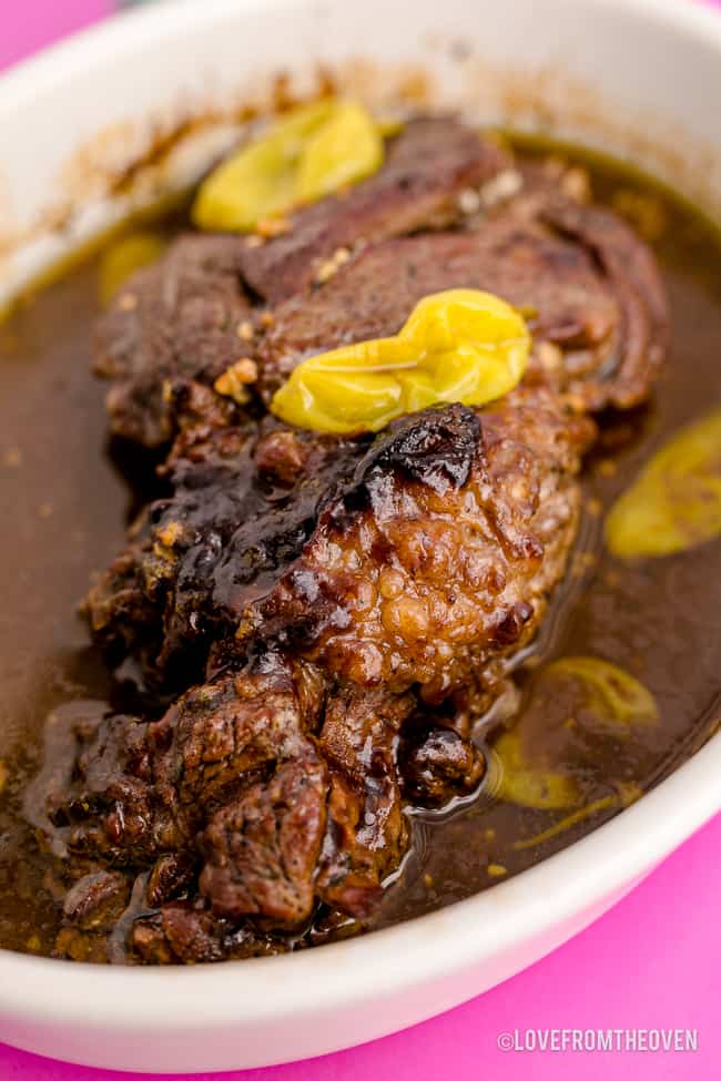 A pot roast in a white dish