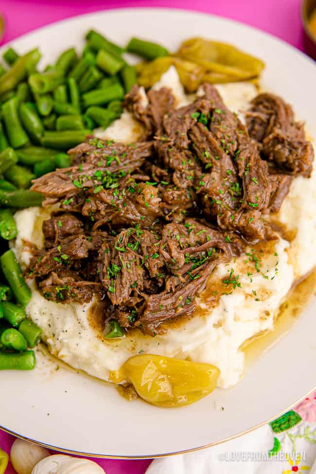 a plate with roast potatoes and green beans