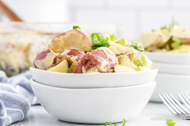 Potato salad in a white bowl.