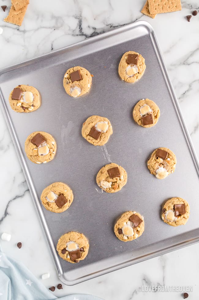 A baking sheet with smores cookies dough on it.