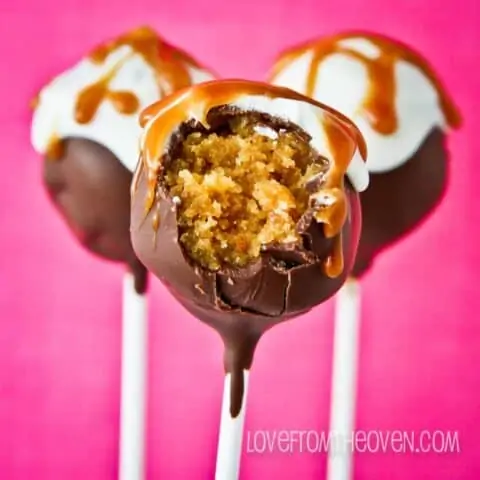 caramel cake pops with a bite taken out.