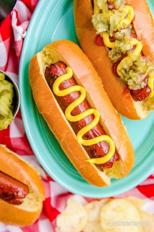 Two hot dogs on a plate.