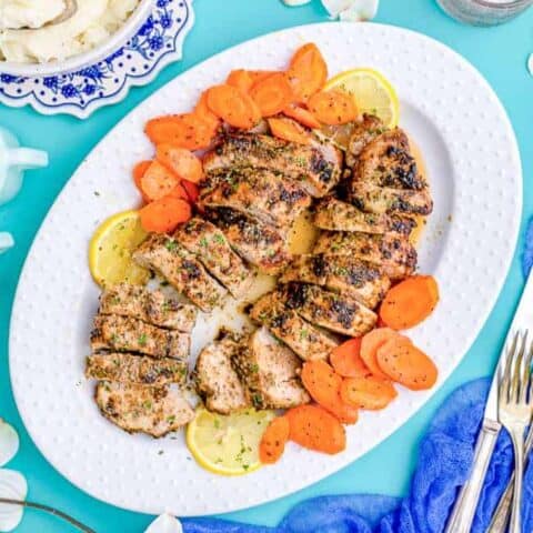 A plate of pork tenderloin with carrots.