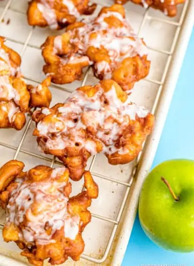 Apple fritters on a baking sheet.