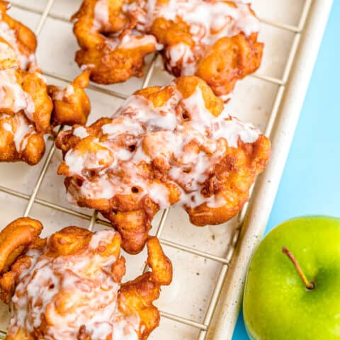 Apple fritters on a baking sheet.