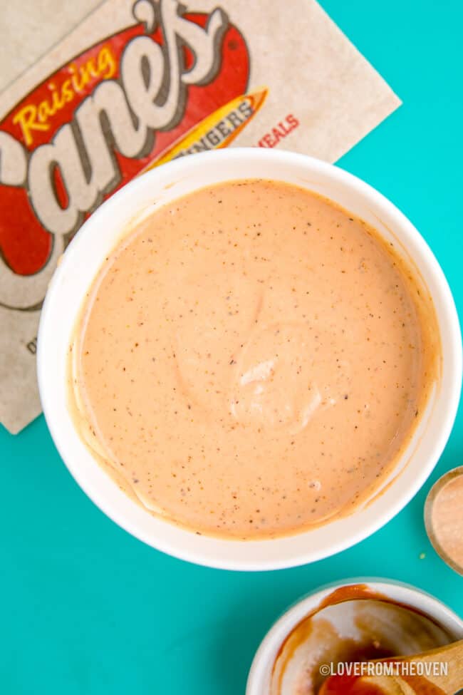 A cup of canes sauce on a blue background.