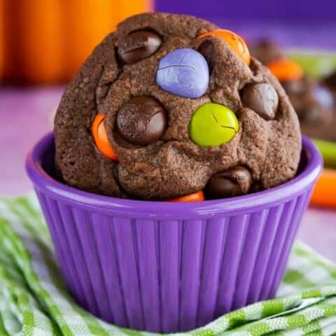 Halloween cookies in a purple bowl.