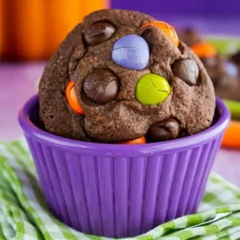 Halloween cookies in a purple bowl.