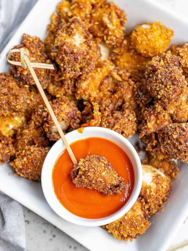 A plate full of chicken nuggets