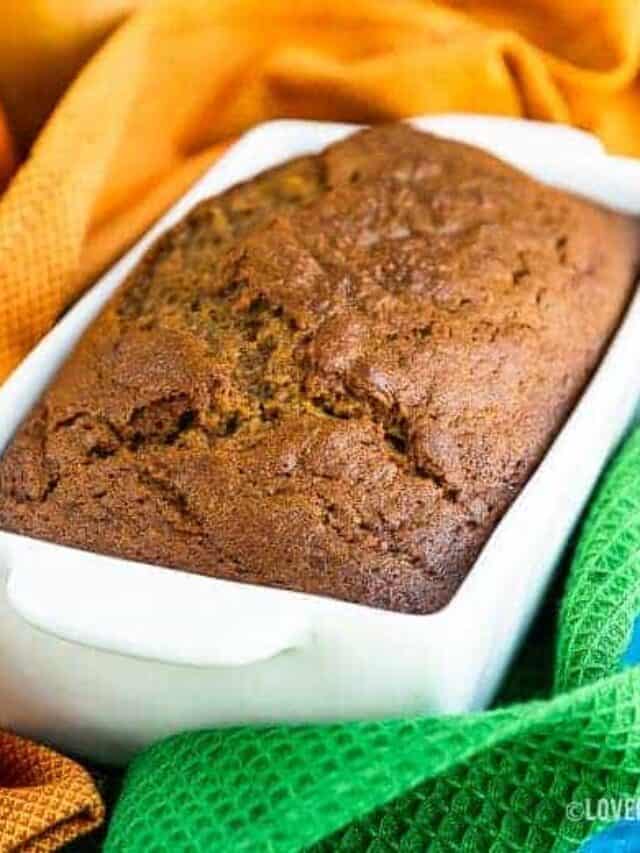 Pumpkin bread in a white bread pan.
