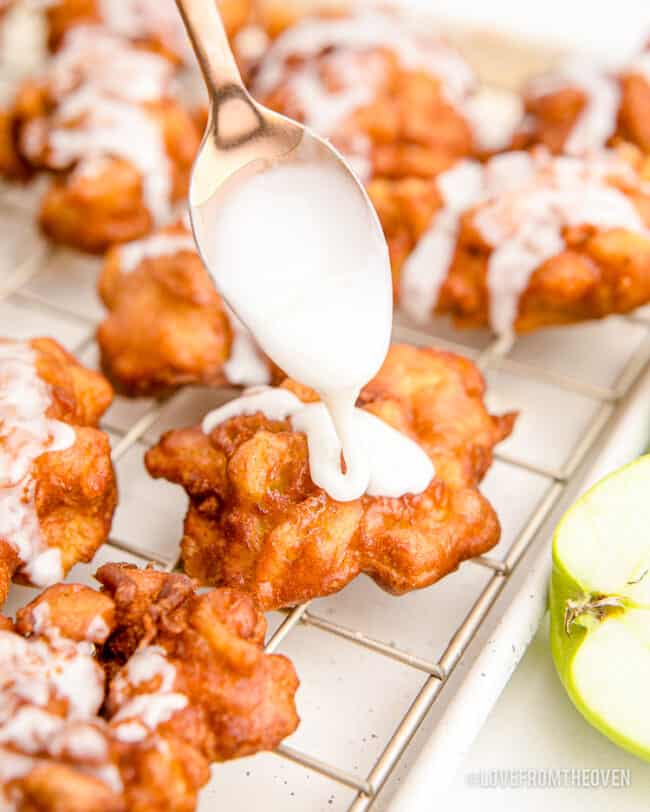 Glaze being spooned onto an apple fritter.