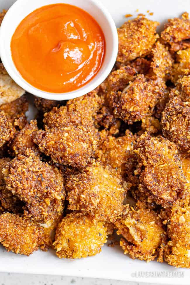 A plate full of popcorn chicken.