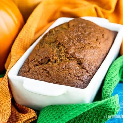 Pumpkin bread in a white bread pan.