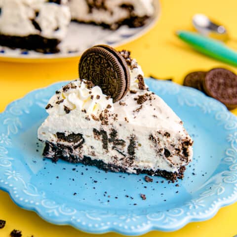 A slice of no bake oreo cheesecake on a blue plate.