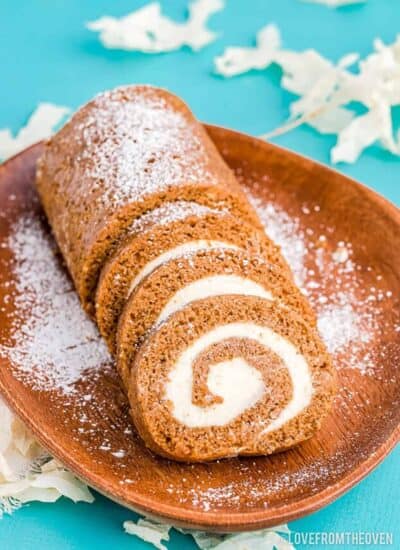 pumpkin roll on a brown plate on a blue table
