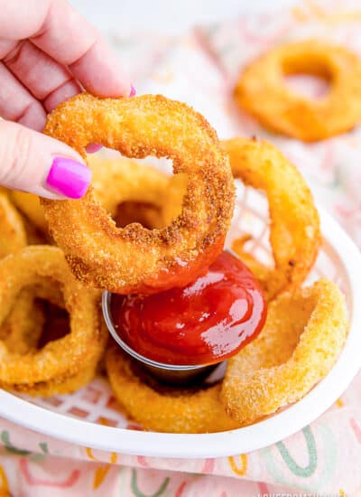 onion ring being dipped in ketchup