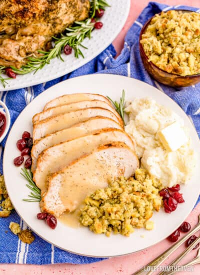 Slices of turkey on a plate with sides and gravy.