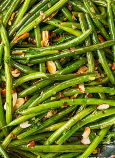A close up photo of green beans almondine.