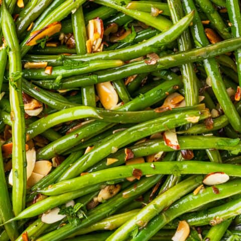 A close up photo of green beans almondine.