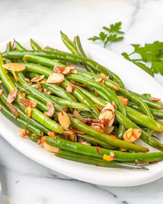 A plate full of green beans almondine.