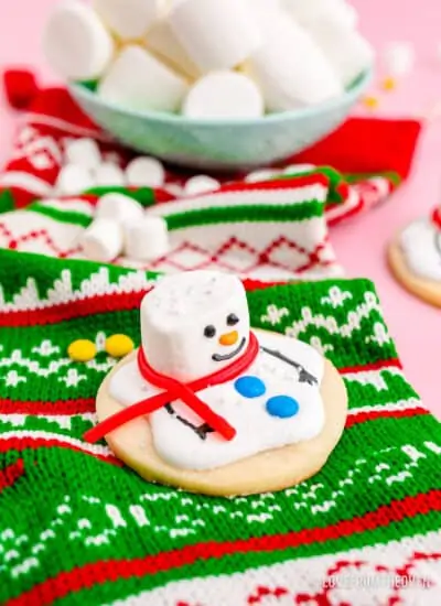 A melted snowman cookie on a christmas stocking.
