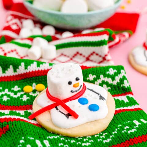 A melted snowman cookie on a christmas stocking.