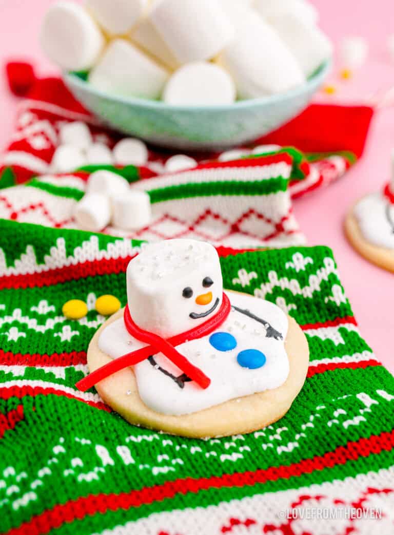 A melted snowman cookie on a christmas stocking.