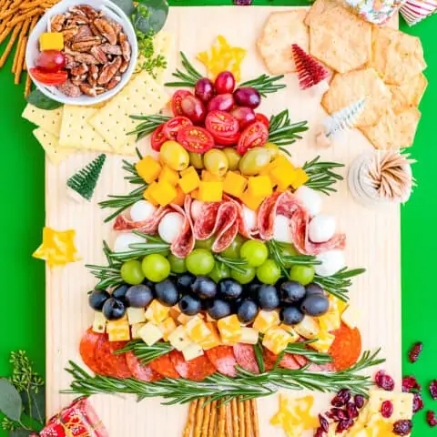 A Christmas charcuterie board on a green background