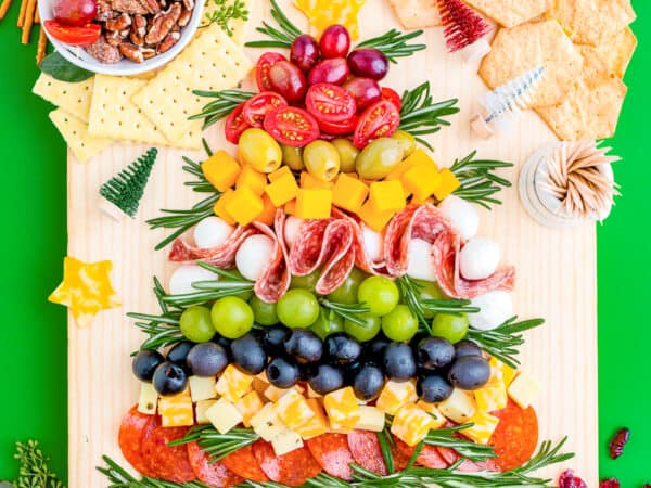 A Christmas charcuterie board on a green background