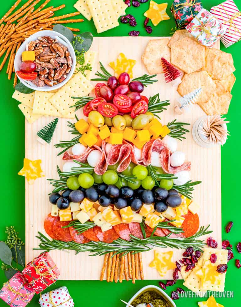 A Christmas charcuterie board on a green background