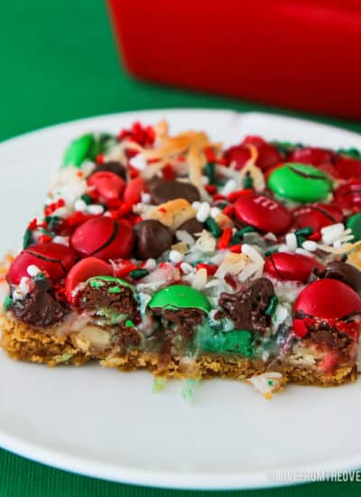 Christmas magic cookie bars on a white plate.