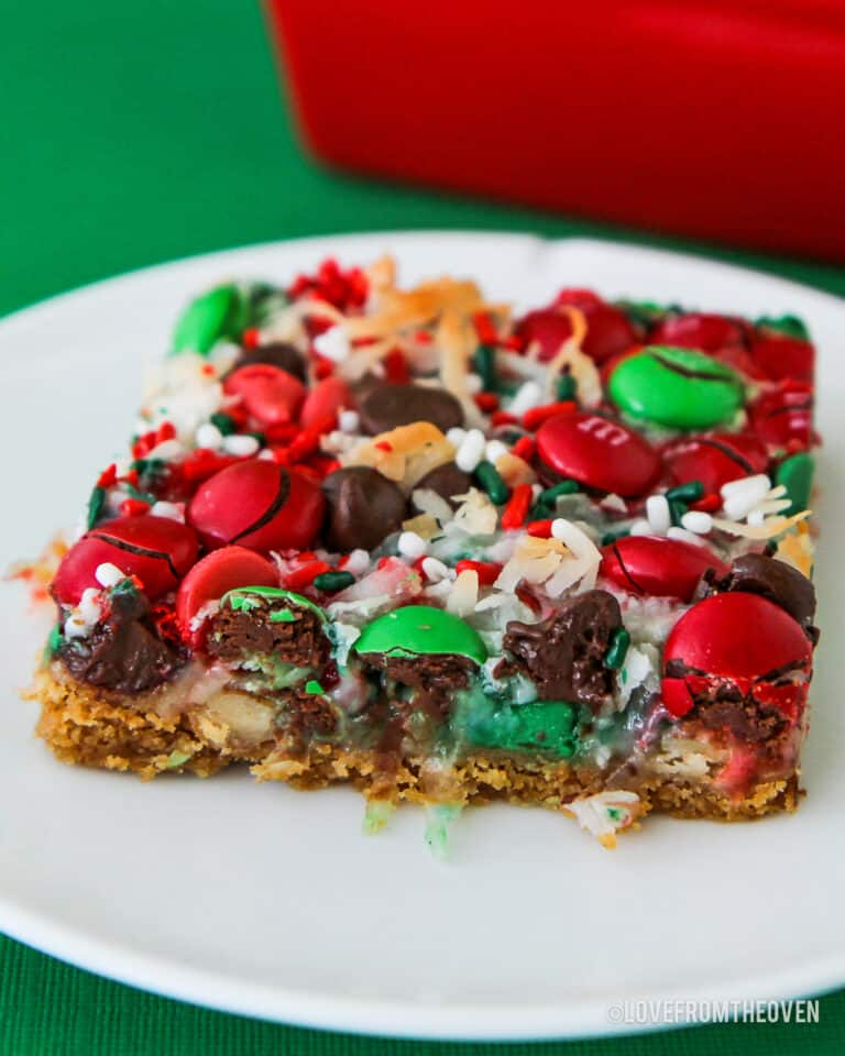 Christmas magic cookie bars on a white plate.