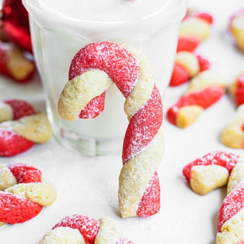 Candy Cane cookies in front of a glass of milk