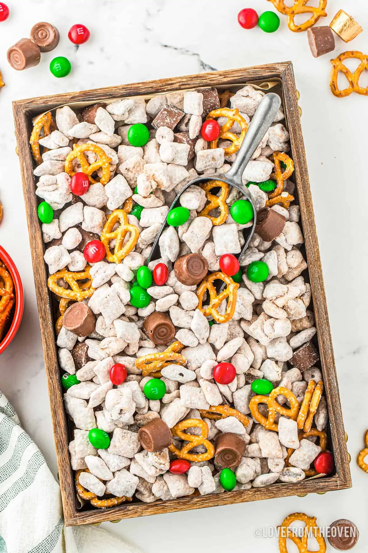 An overhead photo of a baking sheet with christmas muddy buddy mix.