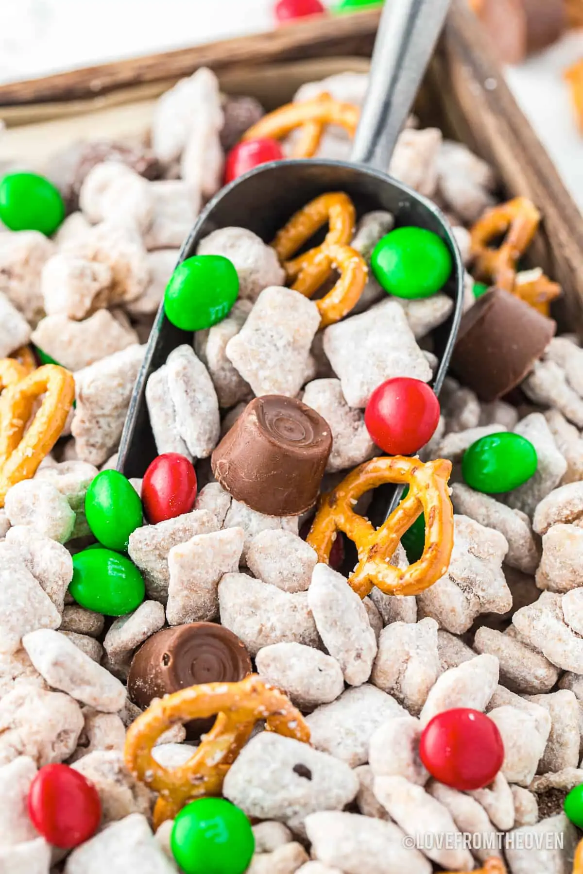 A close up of a Christmas muddy buddies on a baking sheet.