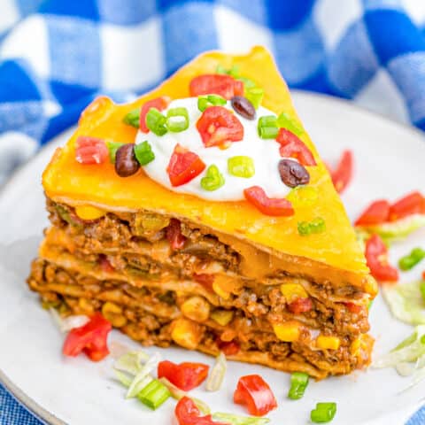A slice of taco pie with a blue and white background.