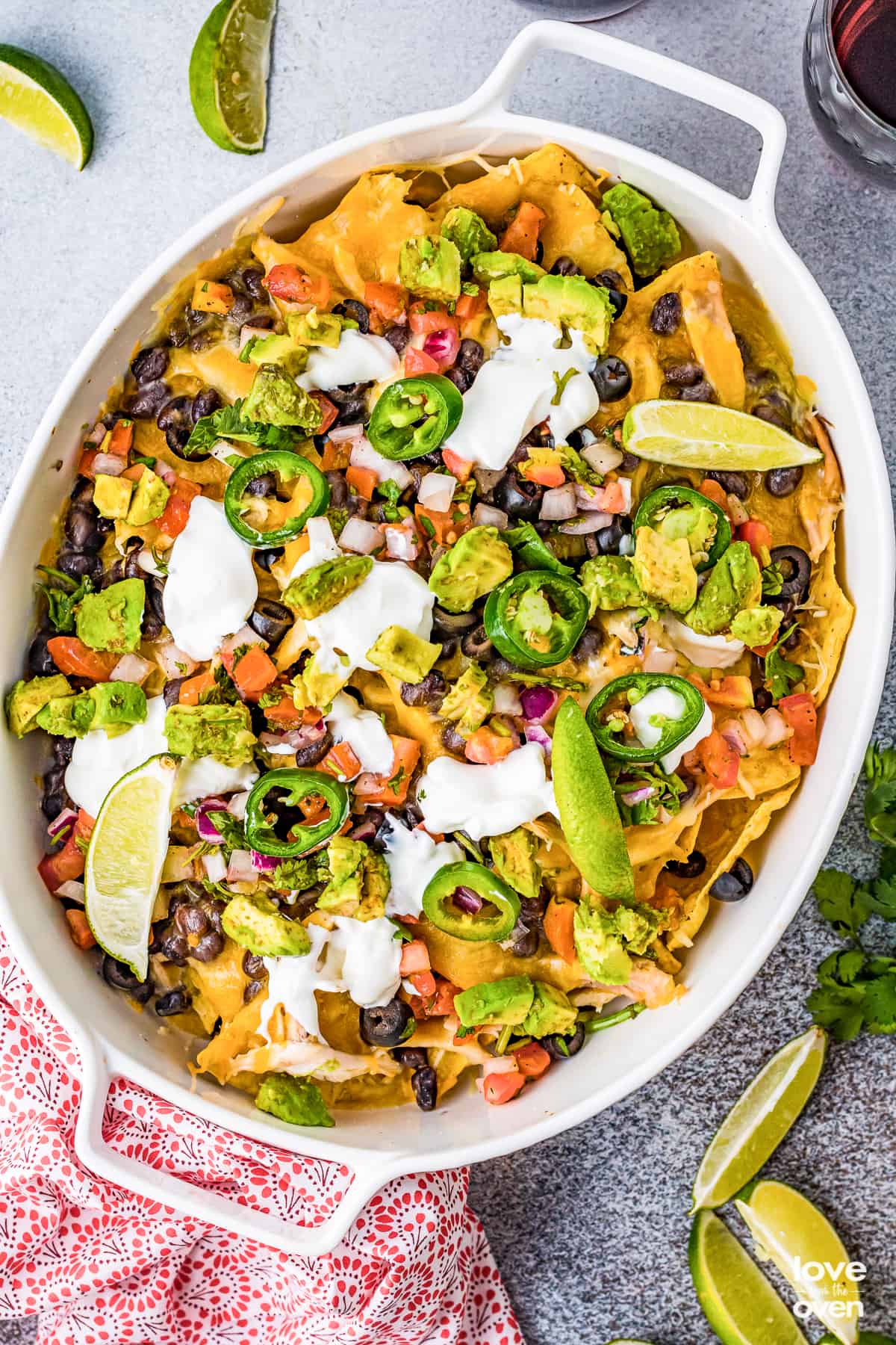 A casserole dish filled with chicken nachos. 