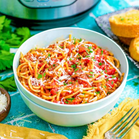 A bowl of spaghetti in front of an instant pot