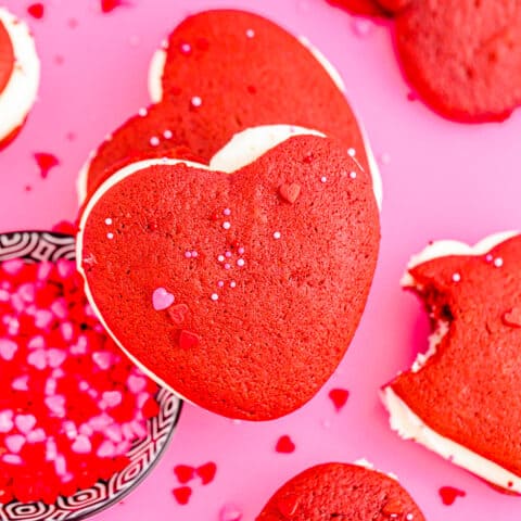 Red velvet whoopie pies on a pink background.