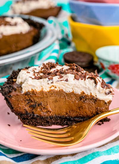 A slice of chocolate cream pie topped with whipped cream.