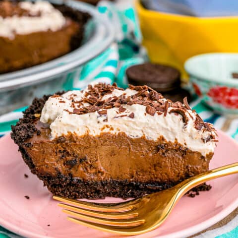 A slice of chocolate cream pie topped with whipped cream.